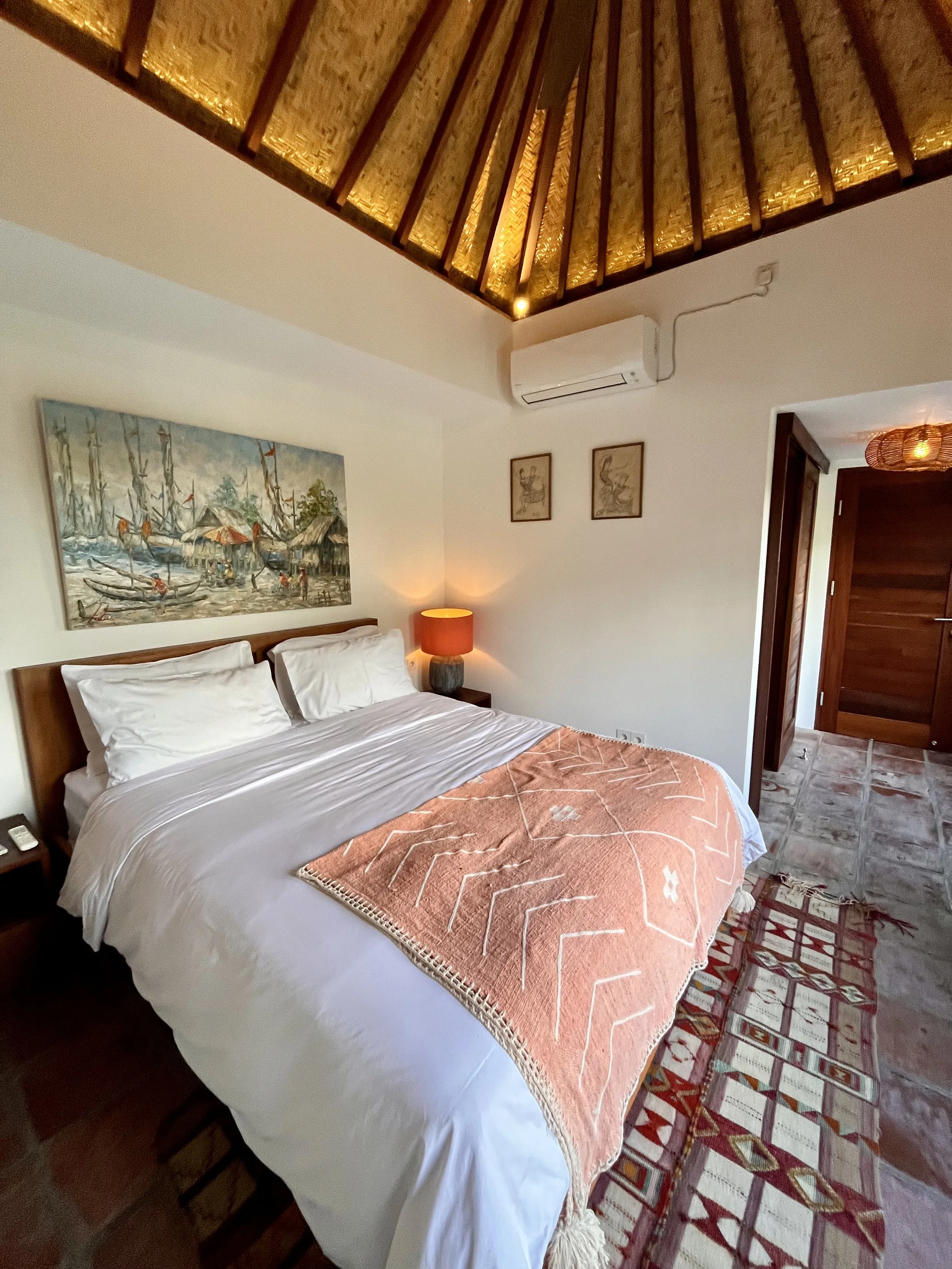 The cozy guest suite with vaulted ceilings, warm lighting and views oit over the pool and ocean.