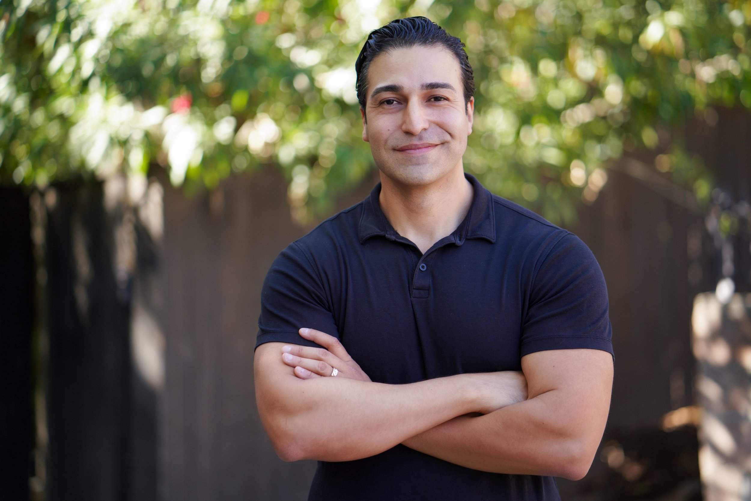 Nelson Grande, candidate for Los Angeles City Council District 1, smiling confidently with arms crossed