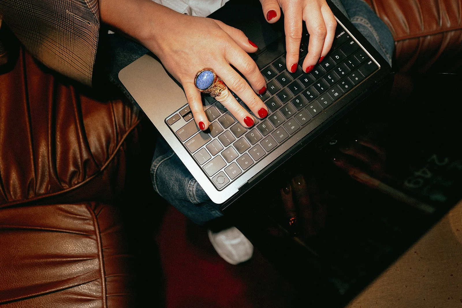 Fingers typing on a Macbook keyboard