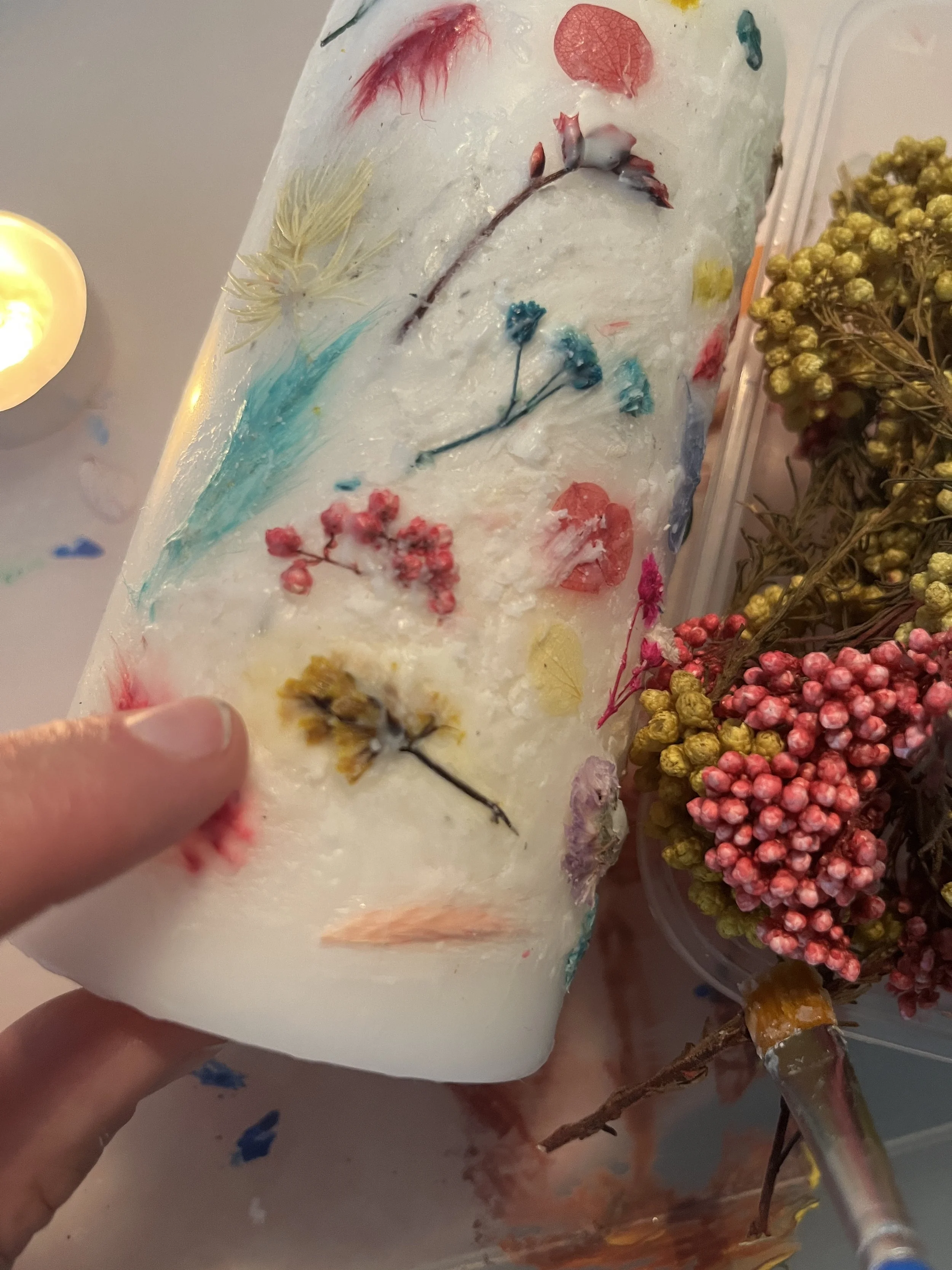3. You need to work quickly with the wax as it dries solid again quite quickly. You can press down the flowers with your fingers...