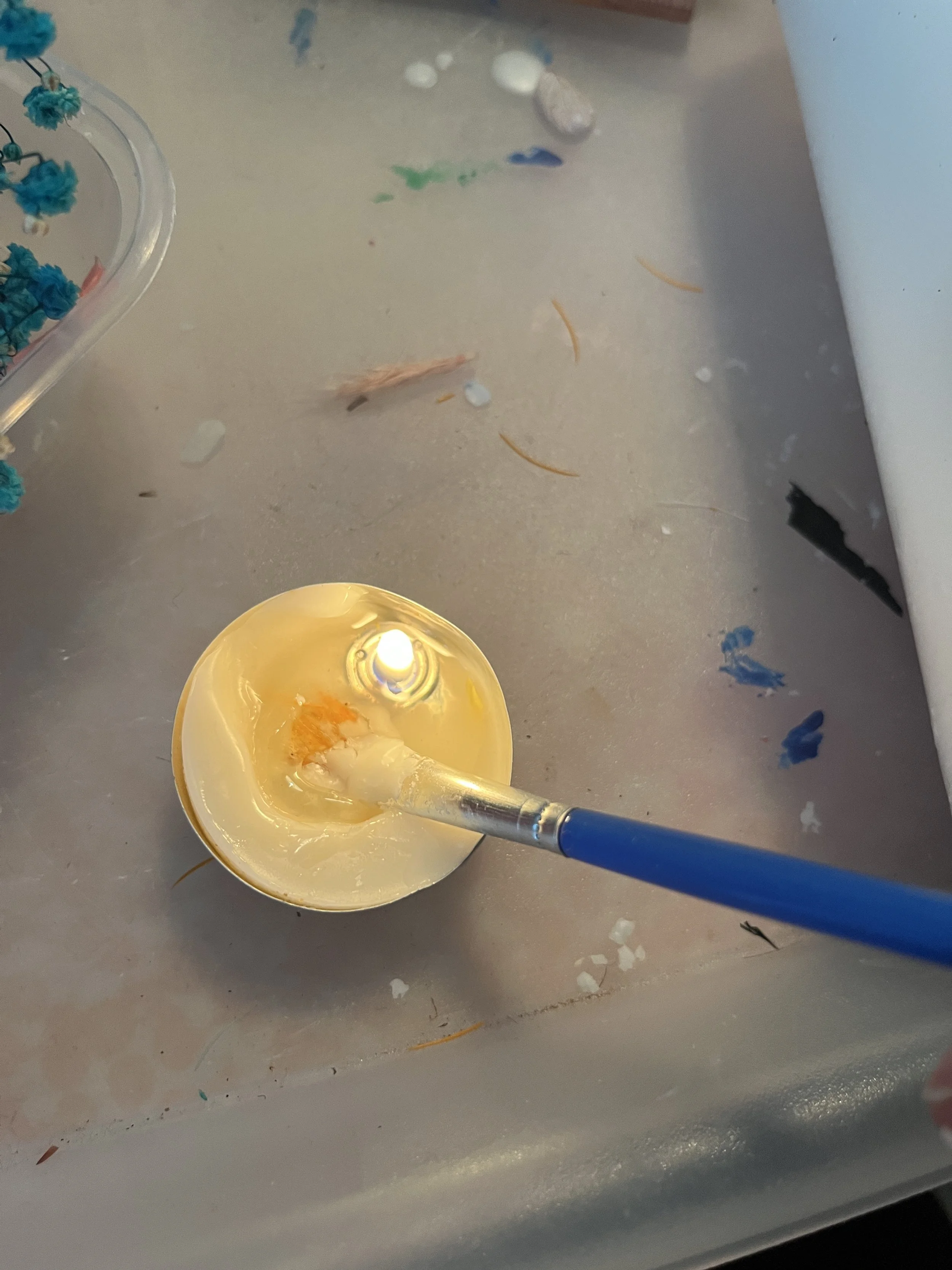 6. Repeat these processes until you have covered your candle all the way around with the dried flowers, using the second tea light for more wax if necessary. 