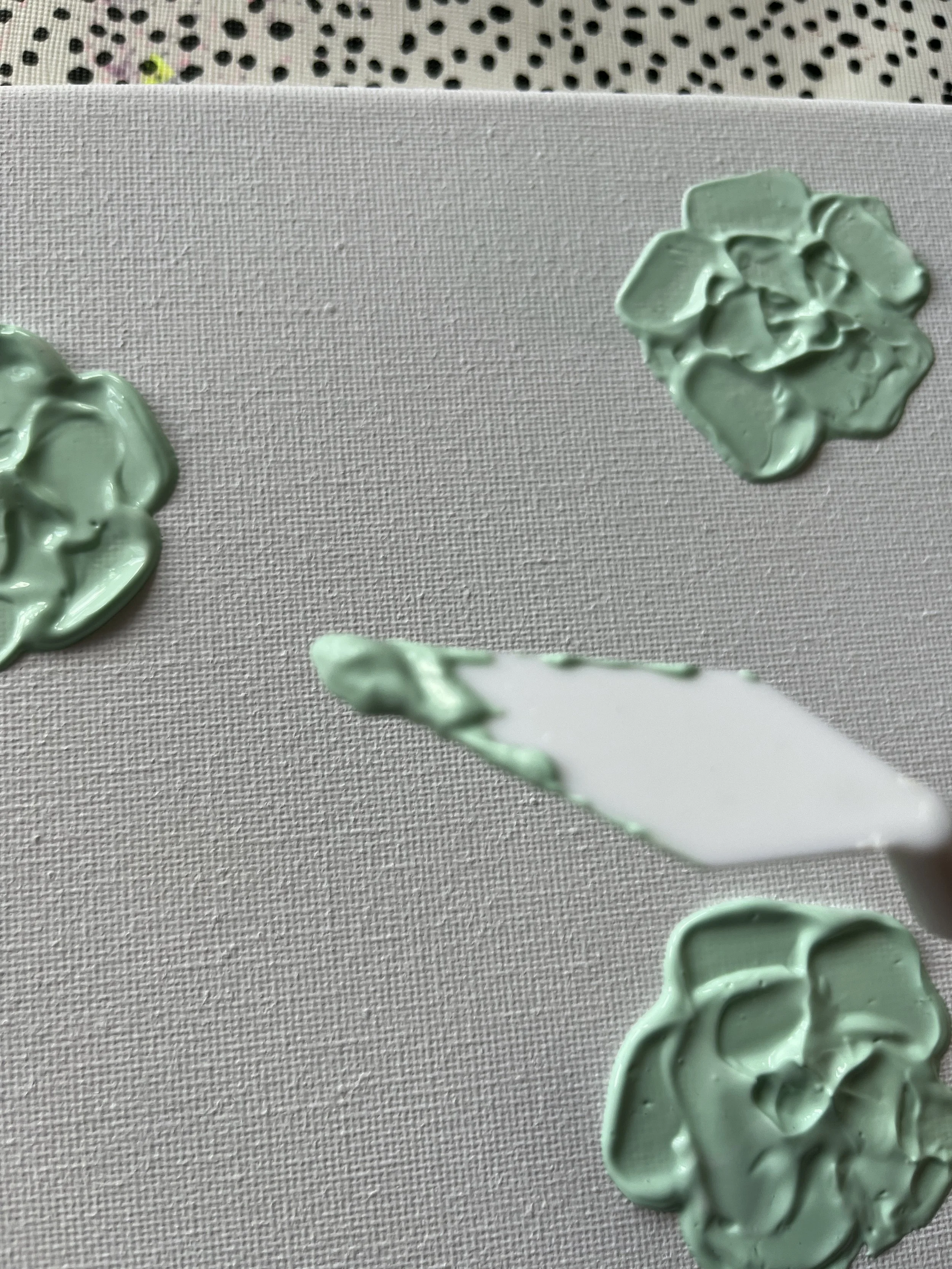 16. Add as many 'rose' style flowers in that colour as you wish. Use one of the 'pointy' knives to create leaf shapes and nice textured 'splashes' to break up the florals.