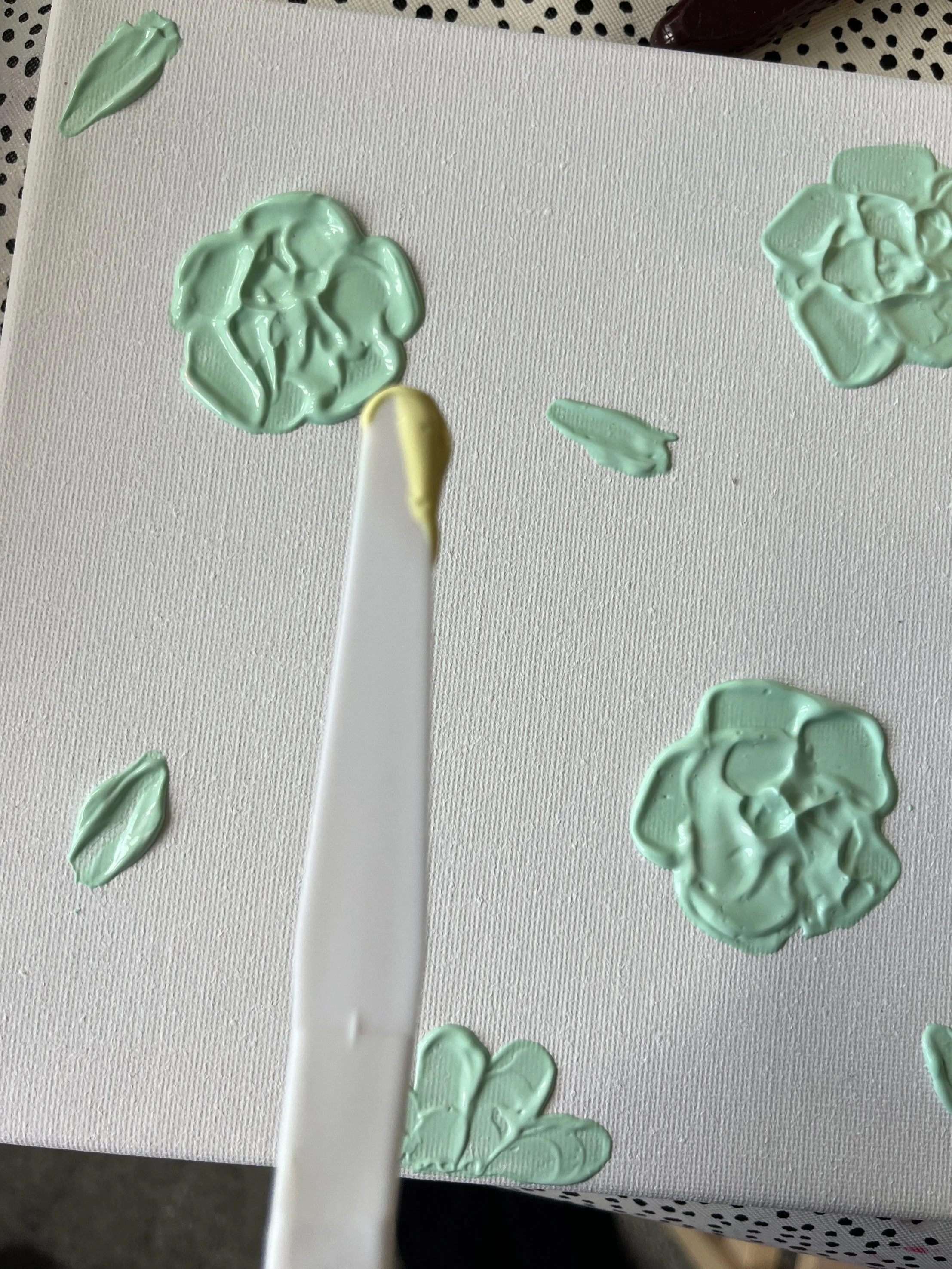 21. Here I have mixed a new colour, pale yellow, to create some 'daisies' using the long, rounded knife. 