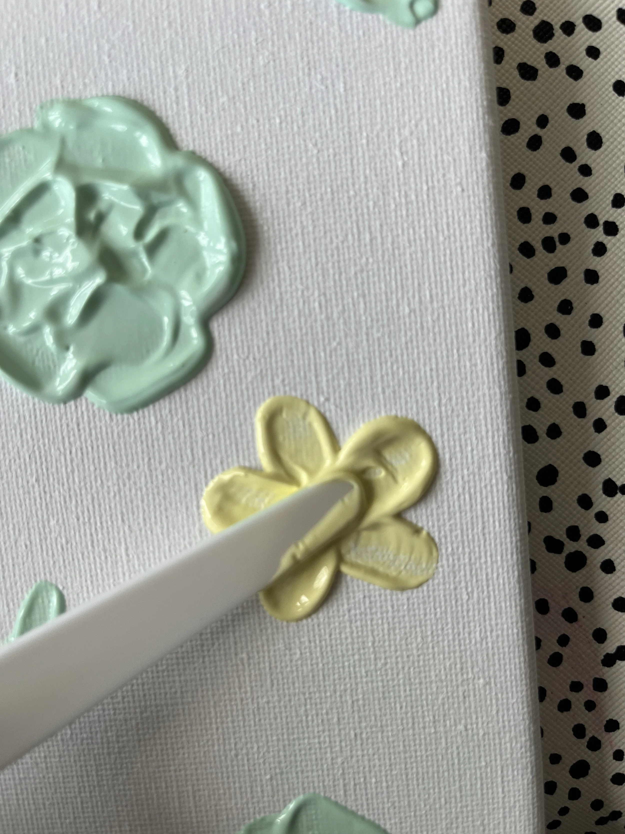 23. Draw towards the middle and turn the canvas so you can repeat all the way round to create the petals.  
Make sure you add enough paste so that you can't see the canvas through the paste, I would add more paste to the bottom right petal here or it