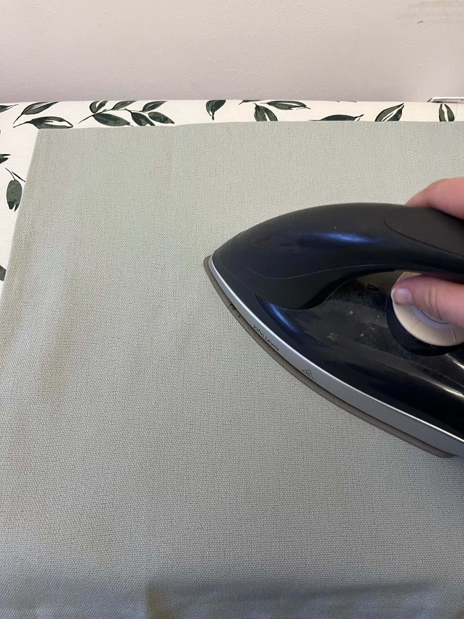 1. Start by taking out your cushion cover and ironing all over. Use a medium setting on your iron and you can always take it higher if necessary.