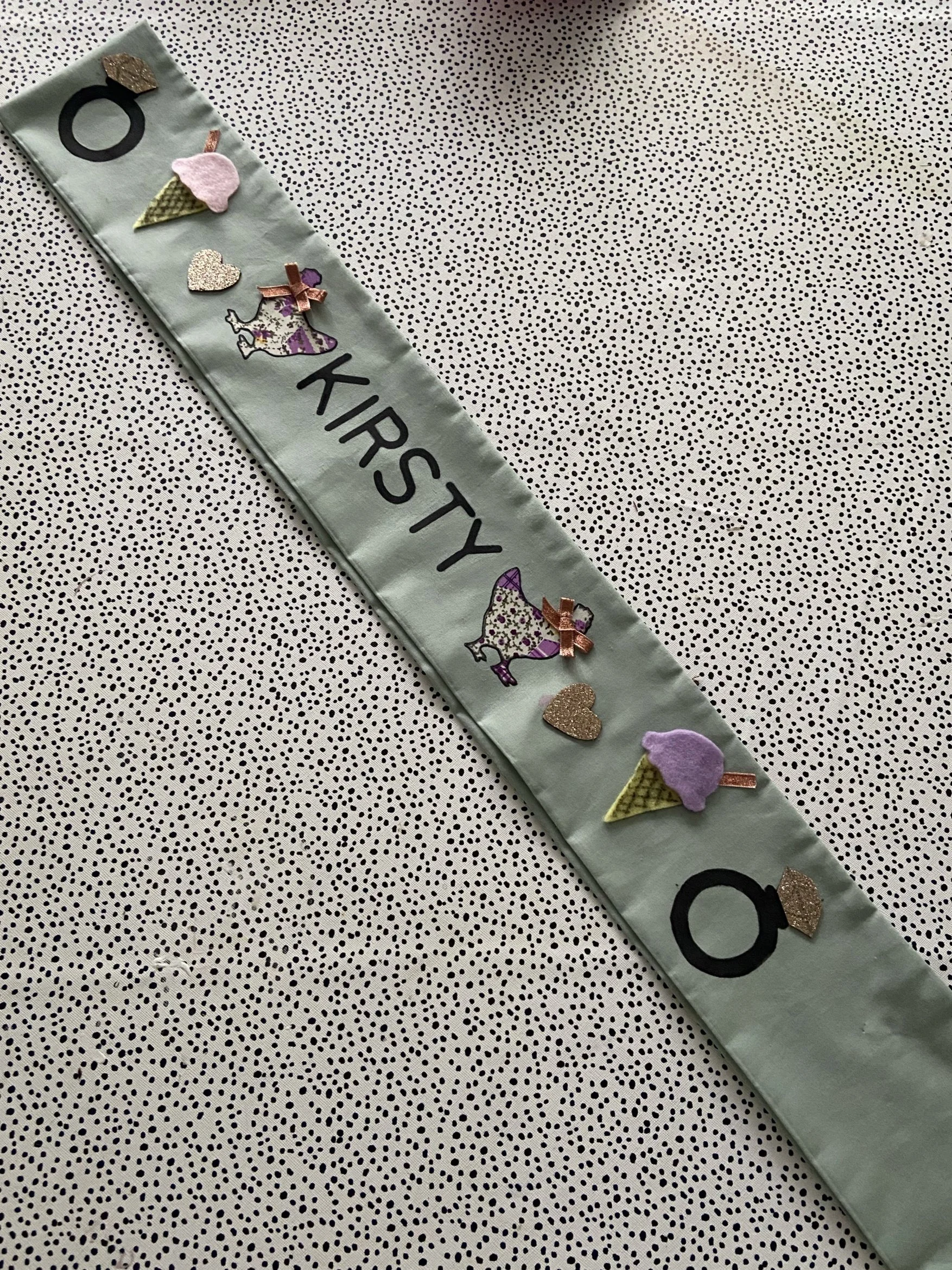 Here is an example of one of the sashes using the hen stencils in your kit, fabrics, felt  and name writing with fabric pens and the alphabet stencils!