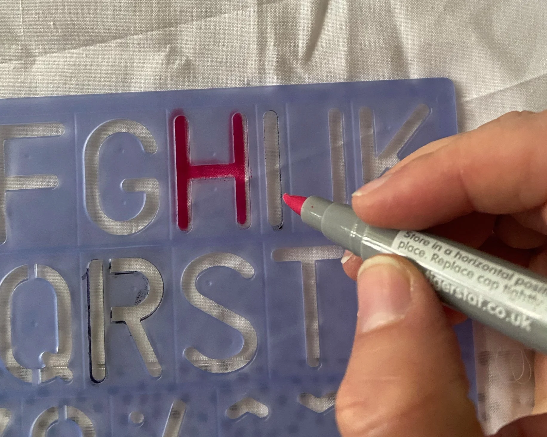 Use your alphabet stencils and fabric pens to create writing directly onto the sash or on lighter coloured cotton. 