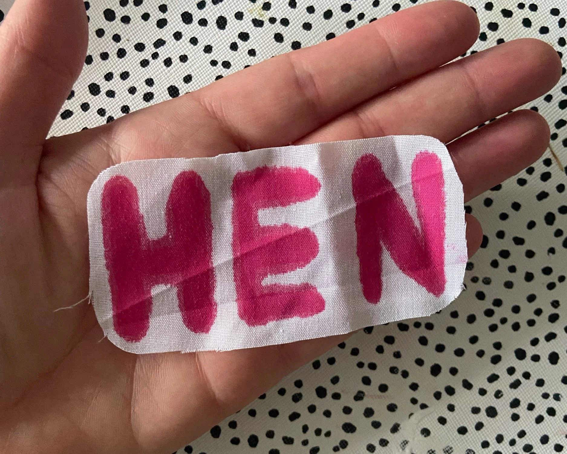 If writing onto the light-coloured cotton,  once you have used the fabric pens, you can cut around it and then attached this piece of fabric directly to the sash using the fabric glue.