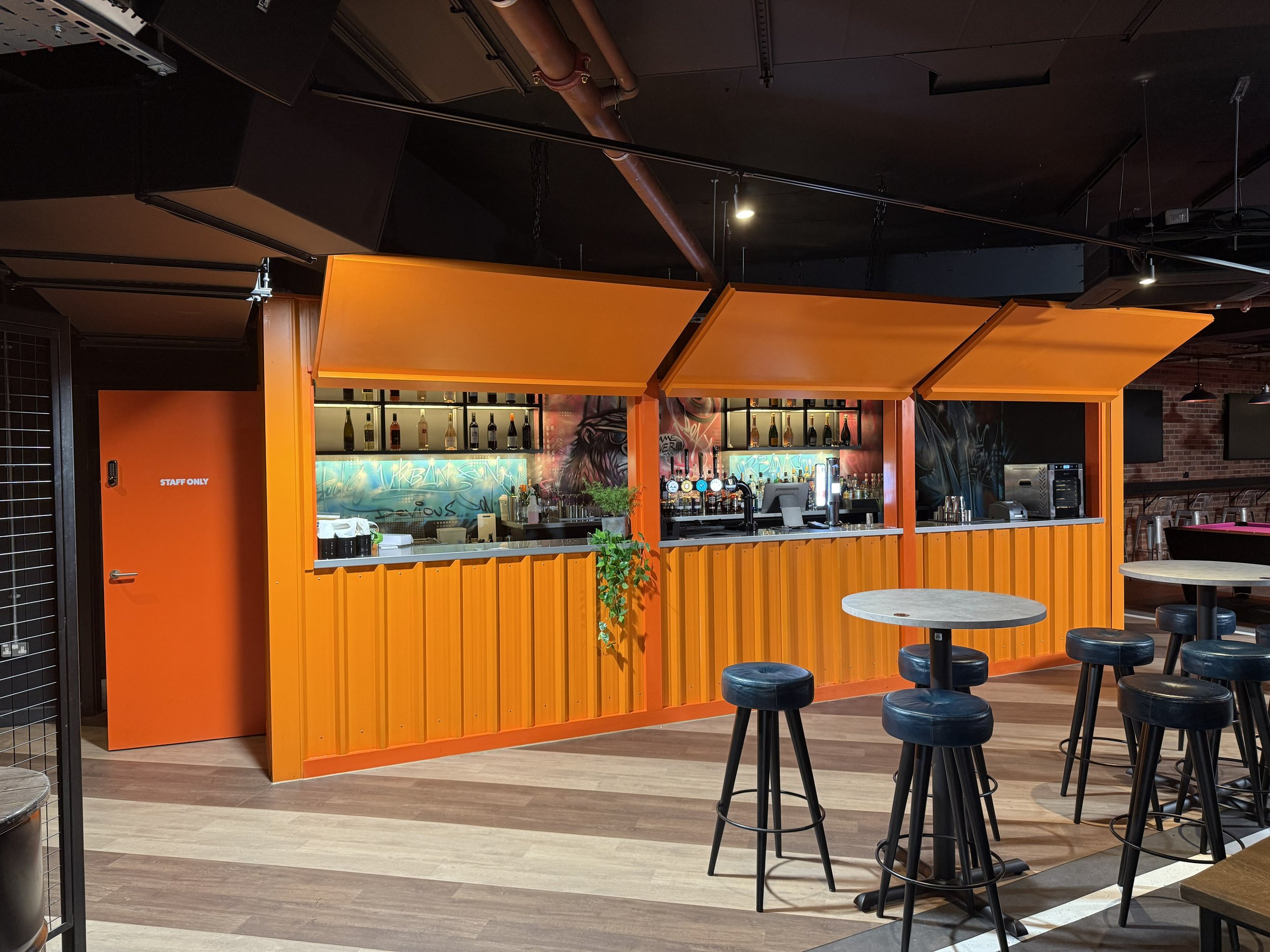 snack hut with stainless bar and back wall shelfving