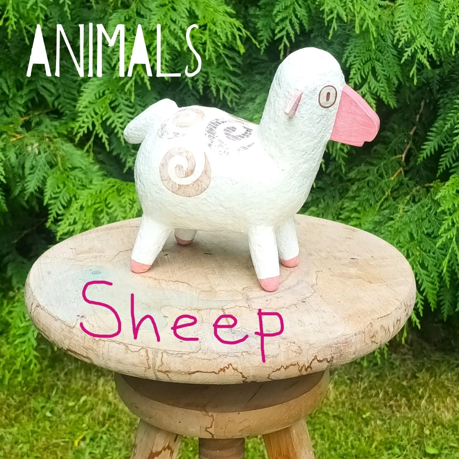 Medium sized Posh Paper Mache mixed media sculpture displayed on a plinth against a background of foliage, photographed in the artists garden. 