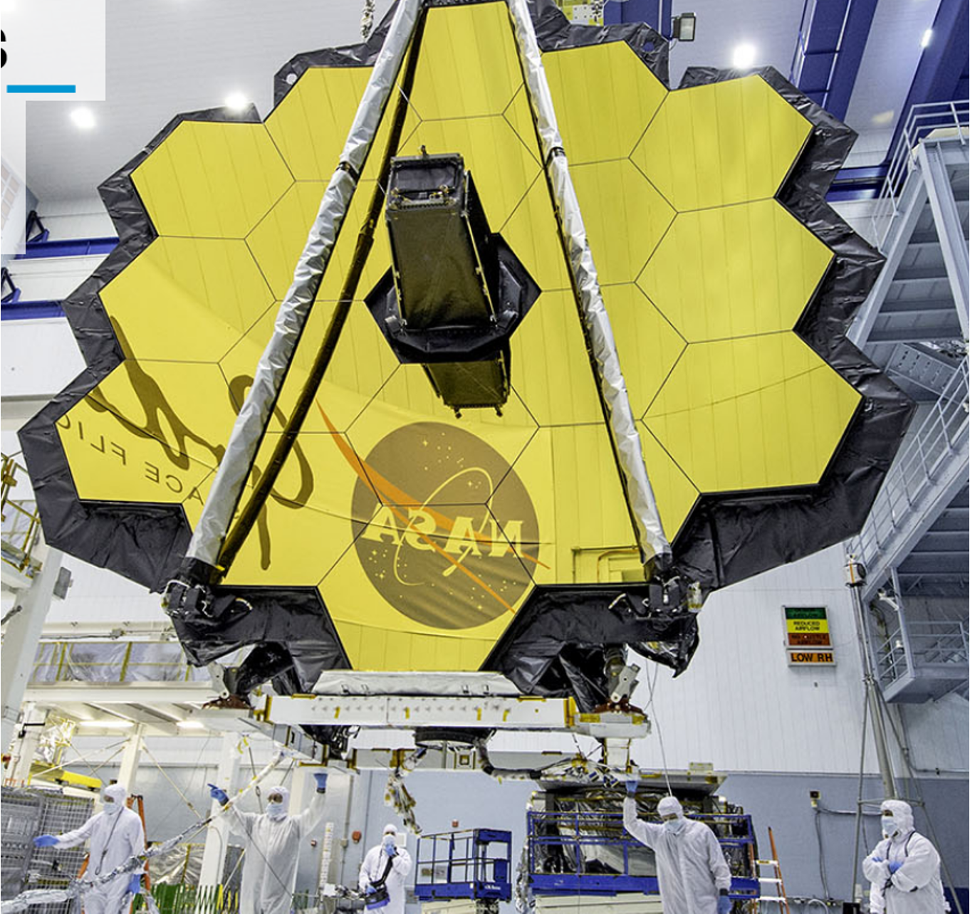 NASA engineers in cleanroom preparing a satellite with a yellow honeycomb-patterned thermal shield in a laboratory setting.