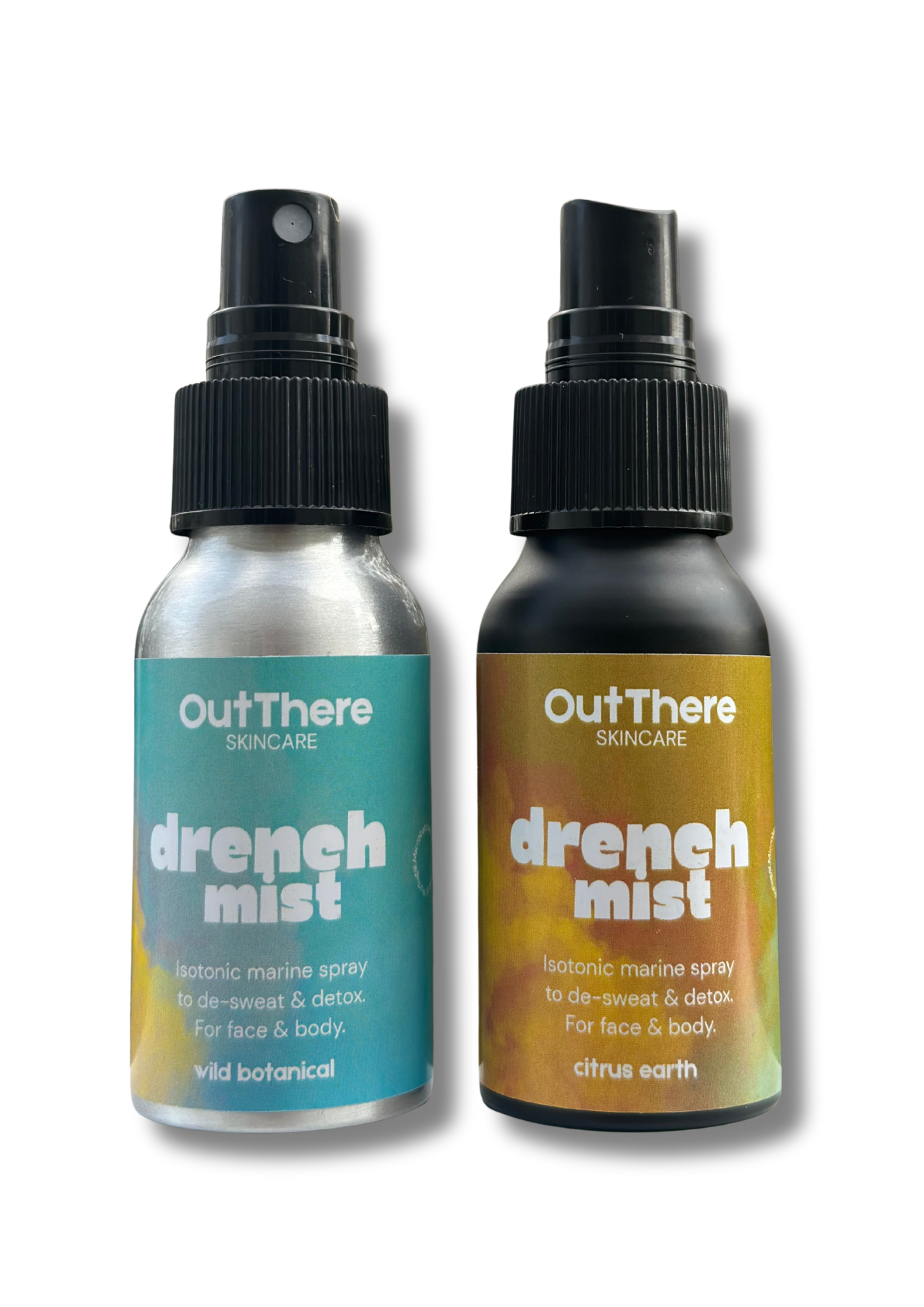Two bottles of OutThere Skincare Drench Mist, an isotonic marine spray for face and body, with one labeled 'wild botanical' and the other 'citrus earth'.