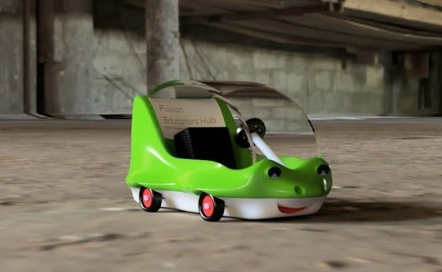 Cartoon green vehicle with a frog face, big eyes, and a clear roof, on a wooden surface.