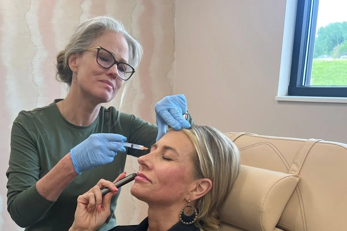A woman receiving a Dermal Filler treatment from a professional at the Skin CLinic, Mankato