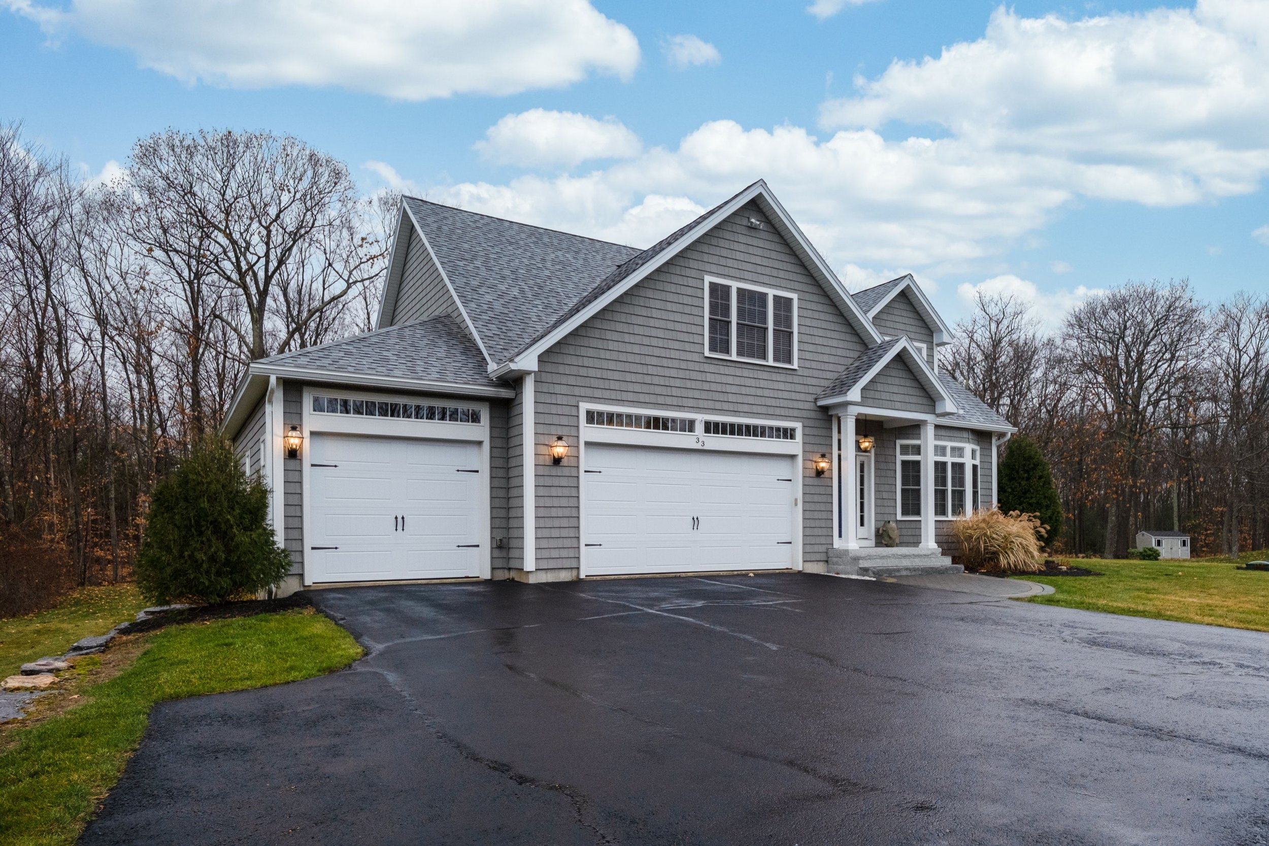 gray-walled-suburban-house-with-white-asphalt-driv-2025-02-11-17-57-29-utc.jpg