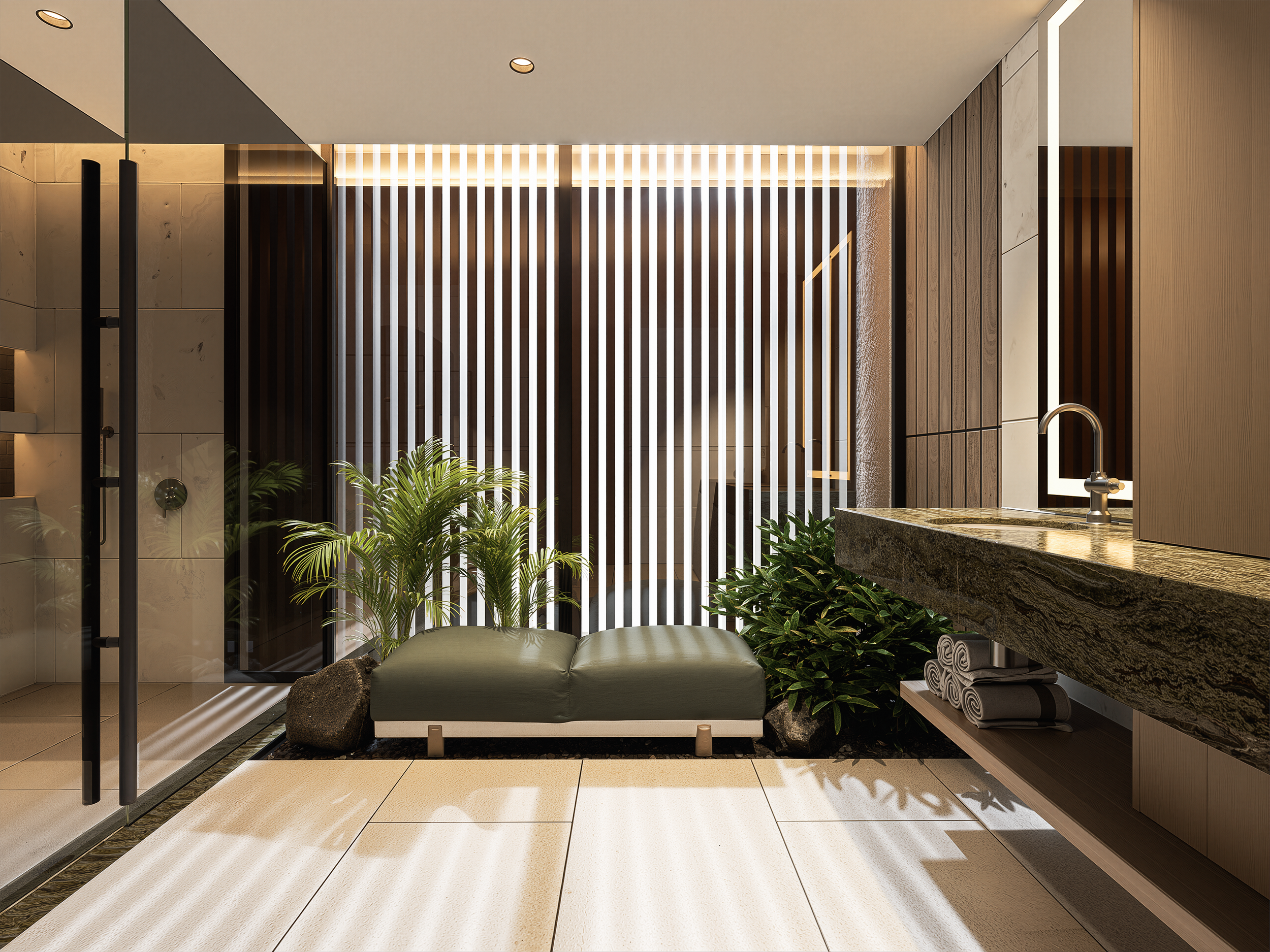 Modern interior space with a leather ottoman, green plants, a granite countertop with rolled towels, a sink, and a decorative wooden slat divider, illuminated by recessed lighting.
