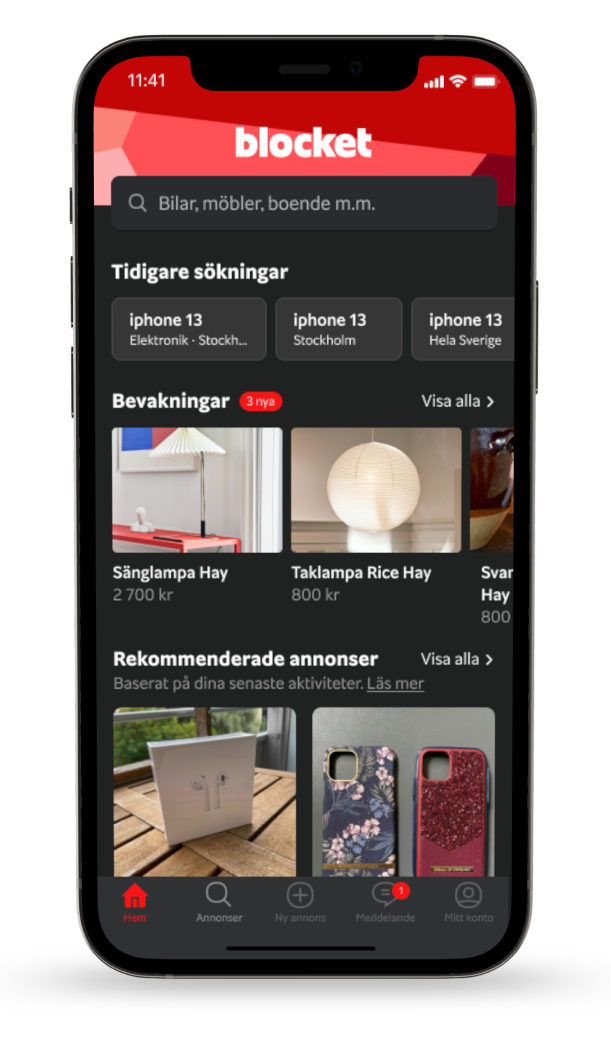 A smartphone display showing the Blocket app with a search bar, recent searches for iPhone 13 in Stockholm and Sweden, listings for lamps including a hay lamp and rice lamp with prices, and recommended ads including wireless earbuds and phone cases, with navigation icons at the bottom for Home, Announcements, Create Ad, Messages, and Profile.