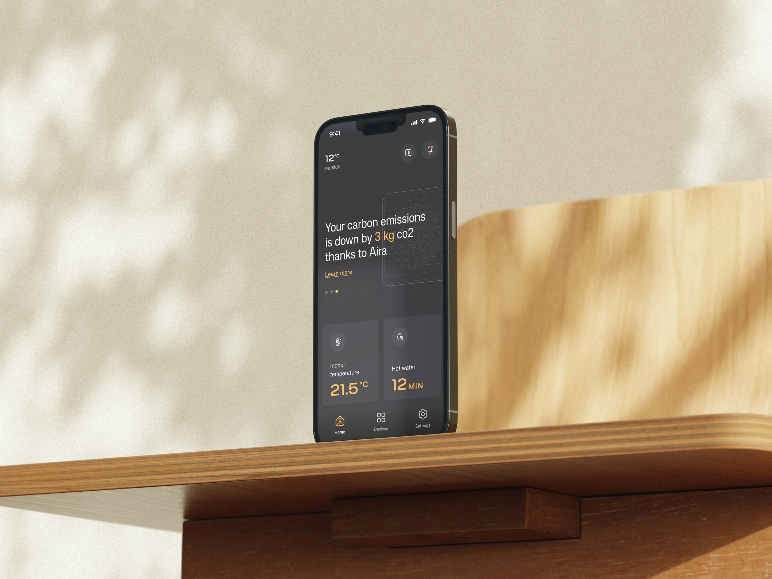 A smartphone displaying a home automation app on a wooden table with a blurred background.