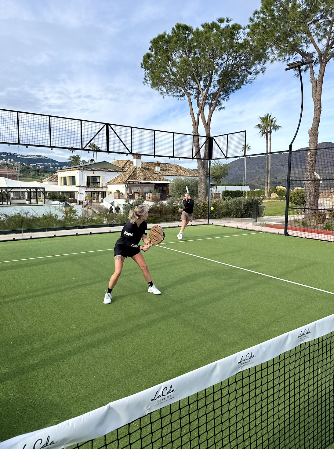 Woman playing pickleball on an indoor court