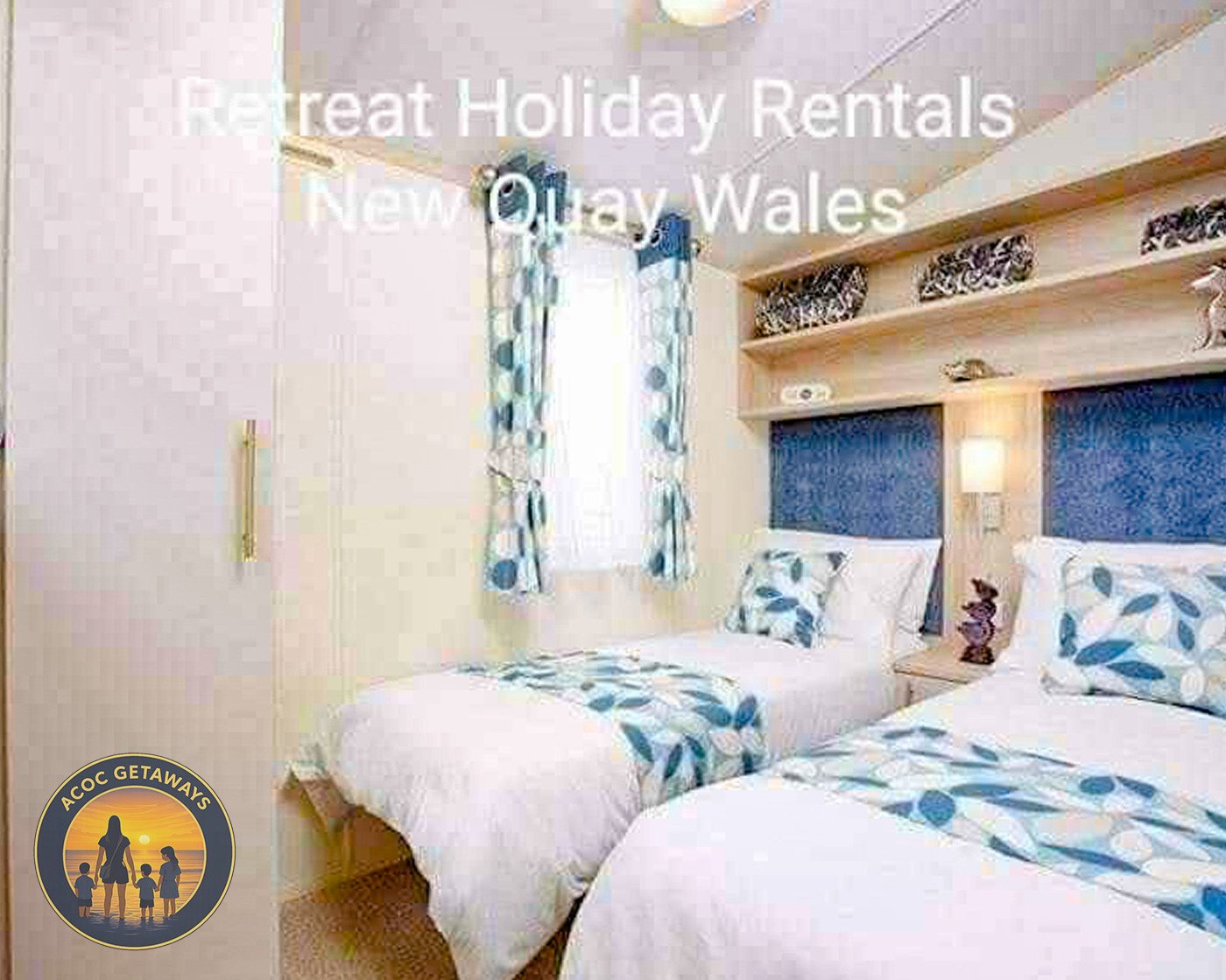 A hotel room with two twin beds, blue and white patterned bedding, a wall-mounted lamp, a decorative shelf with items, a window with matching curtains, and a beige wall.