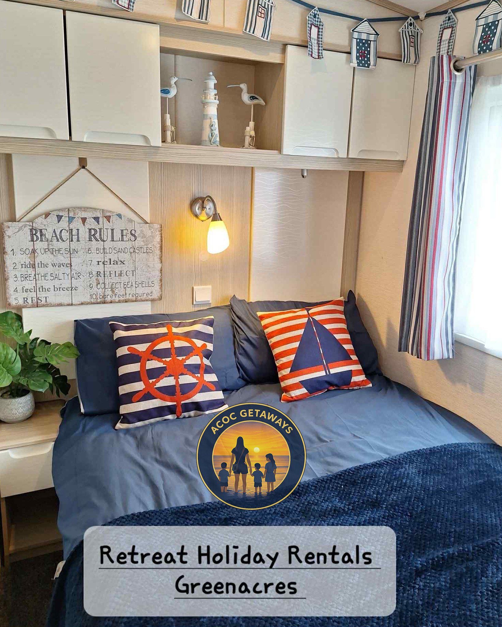A cozy bedroom with nautical decor, featuring two striped pillows with sailboat and ship wheel designs, a 'Beach Rules' sign, a tree with leaves on a small side table, and a window with striped curtains. There is a logo with a sunset, a woman and children, and the text 'ACOC Getaways' along with a label that reads 'Retreat Holiday Rentals Greenacres'.