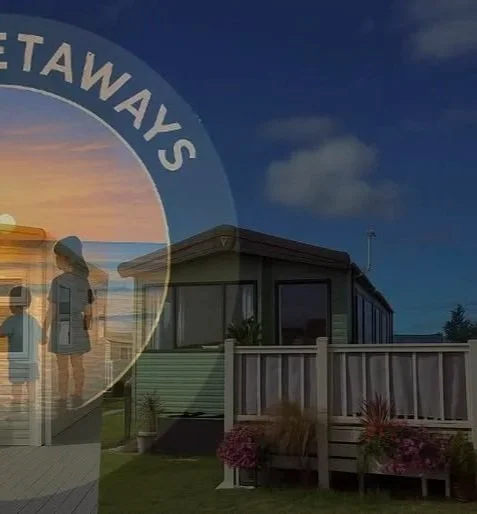 A house with a fenced yard and flowerbeds in front, under a clear blue sky, with a circular overlay showing children at the beach during sunset and the word 'Tawaias' in a curved font.
