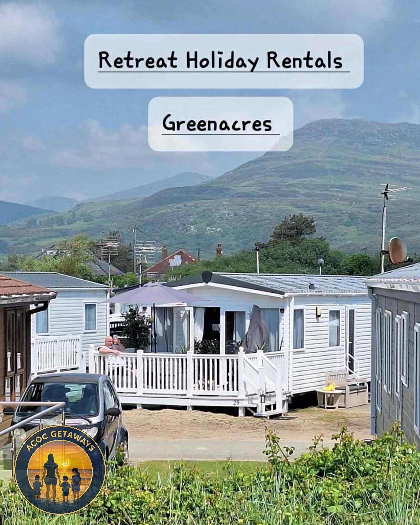 A scenic view of a small holiday rental cabin with a white porch and umbrella, surrounded by other similar cabins, with green mountains in the background, and a logo for ACCC Getaways in the lower left corner.
