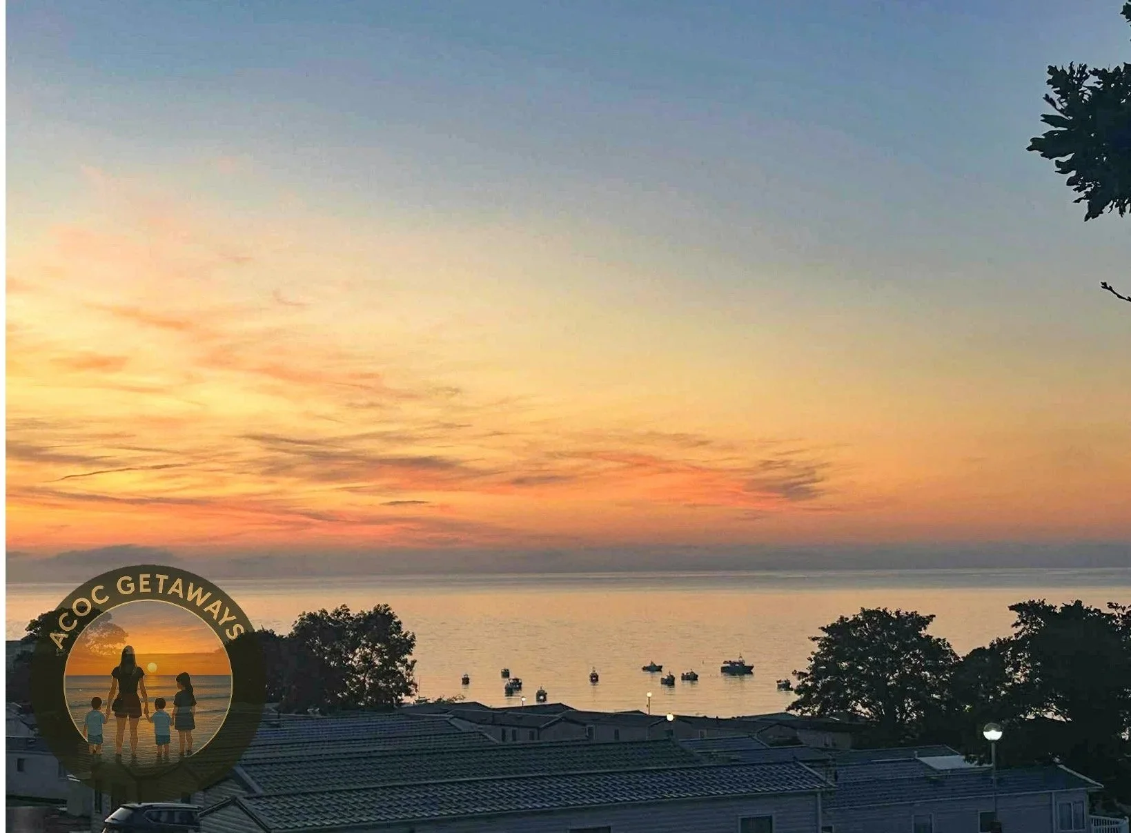 Sunset over the ocean with boats, trees, and rooftops in the foreground, and a logo in the lower left corner featuring a woman and children at the beach with the text "ACOC GETAWAYS."