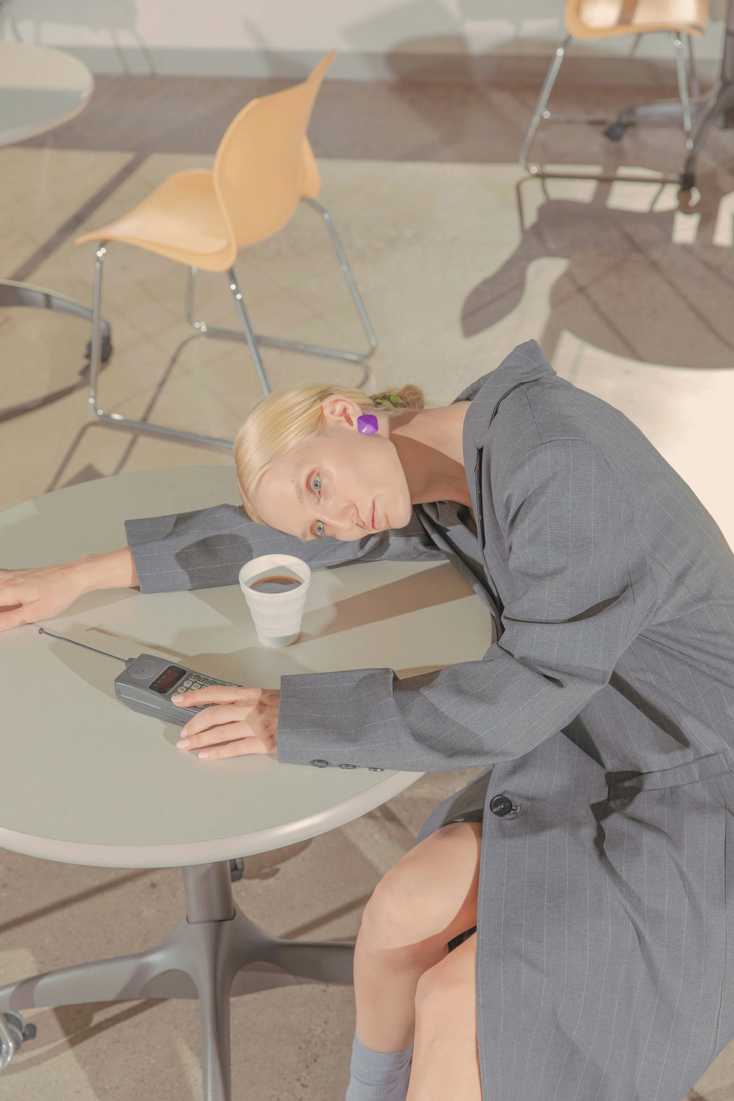 woman-on-cell-phone-tired-laying-on-desk-therapy