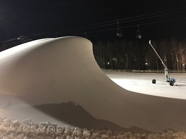 	
SMI Snowmakers Grizzly snowmaking stick making snow with a huge snow pile.