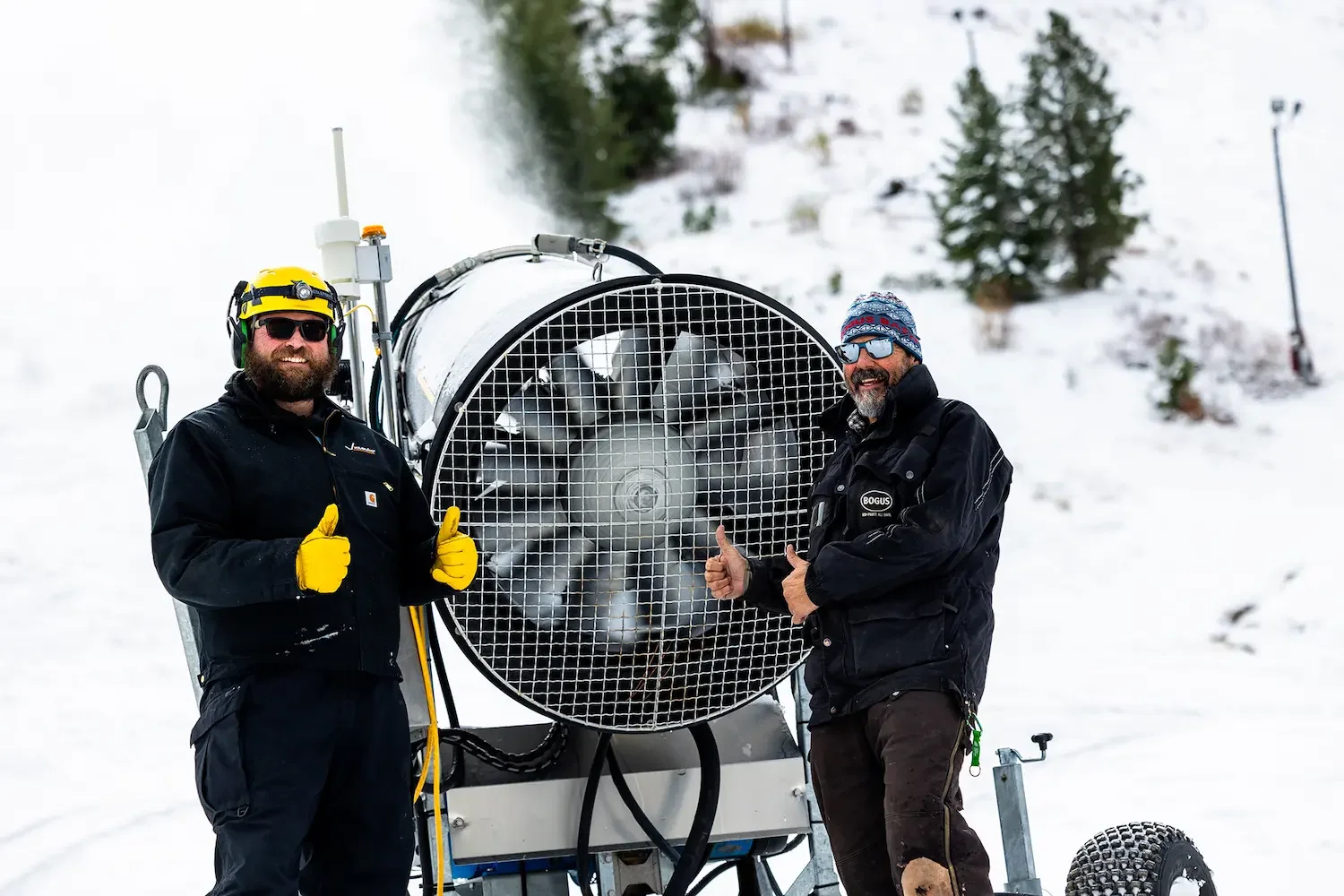 JonathanOstrowSnowMakingManagerAndRobHarmsSlopesManagerStandingNextToSnowMakingFanWinter2024AtBogusBasin_112024_PhotoByCassidyCarter_2084x1389 copy.webp