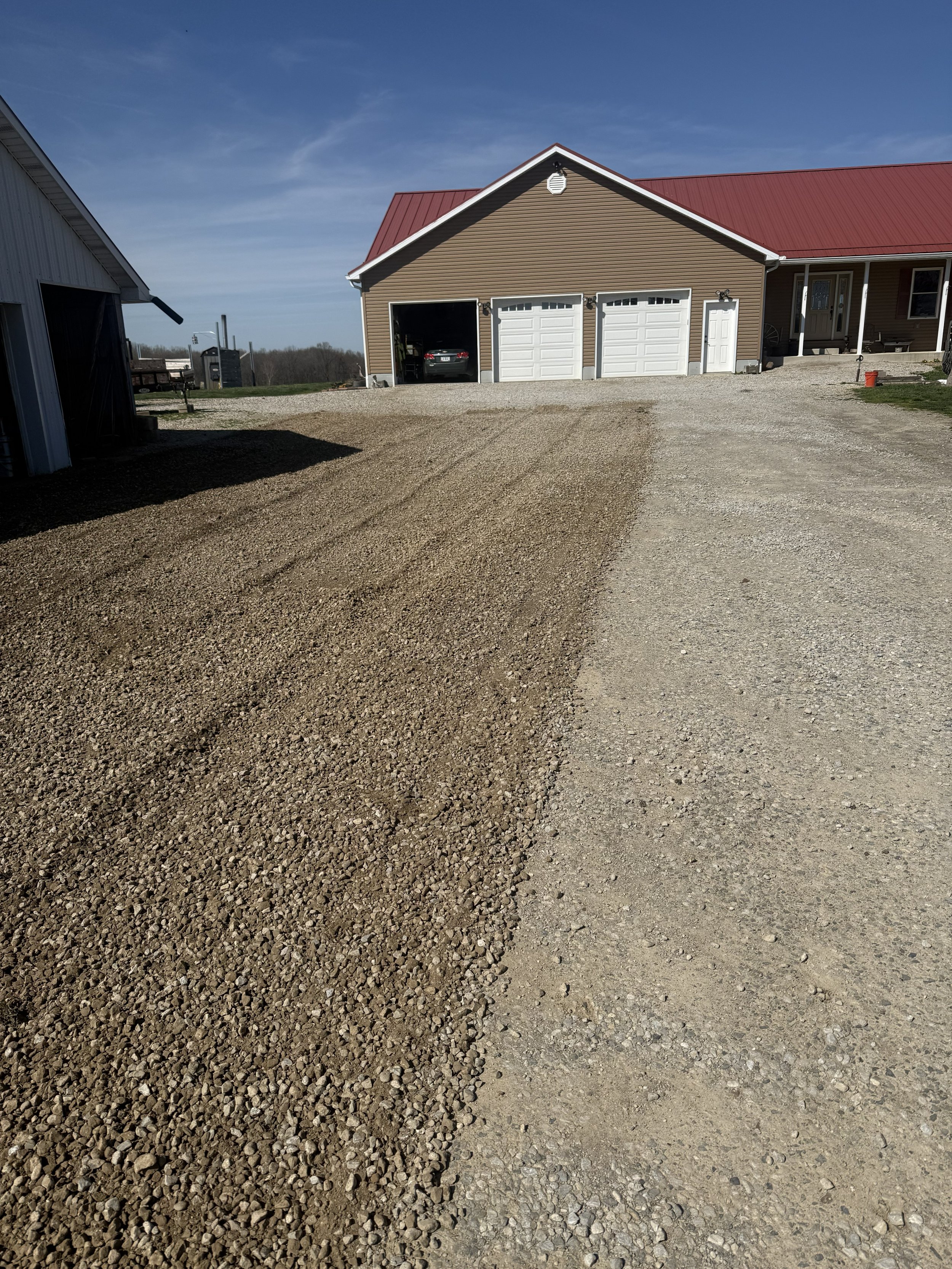 Resurfacing a gravel driveway to remove rutting and storm damage