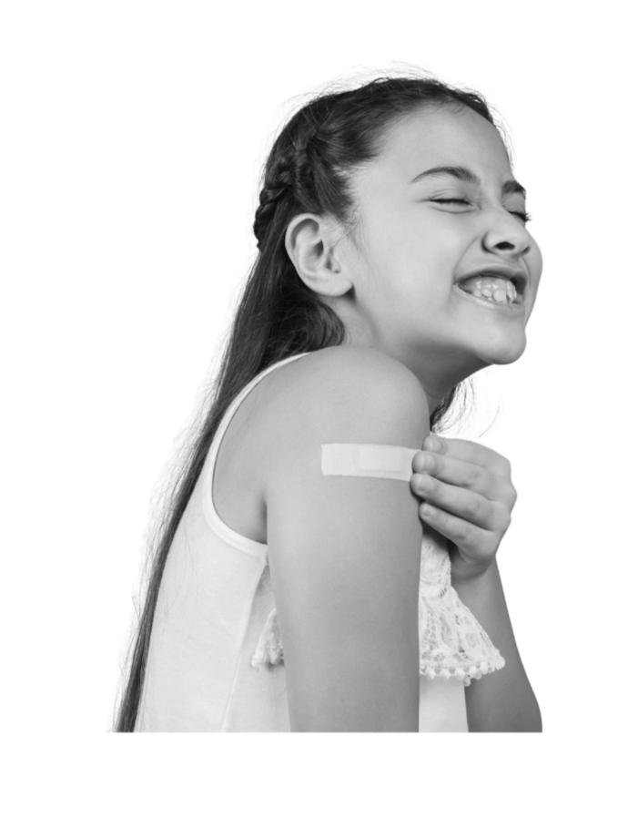 A teenage girl grimaces and pretends to remove the band-aid stuck on her shoulder, following vaccinations.
