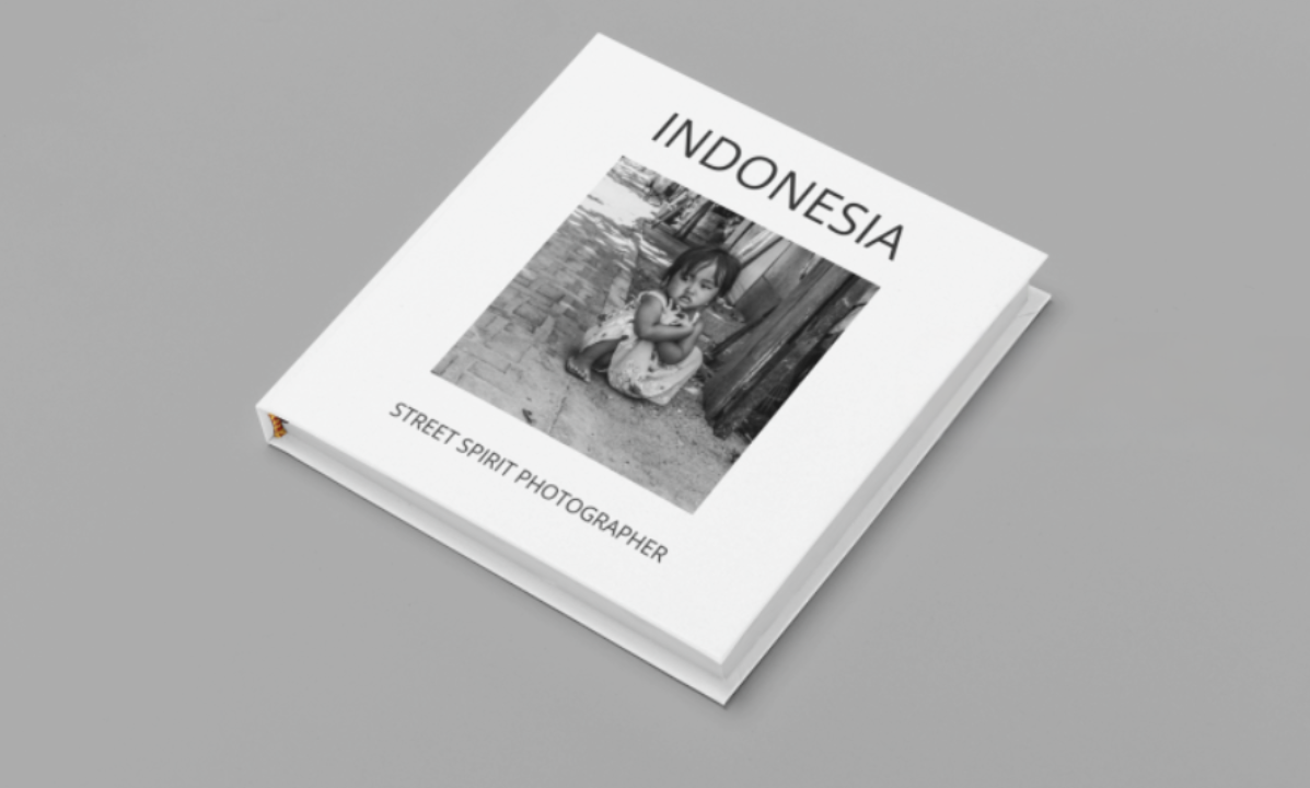Book titled 'Indonesia' with a black and white photo of a girl sitting on a street, labeled as 'Street Spirit Photographer'.