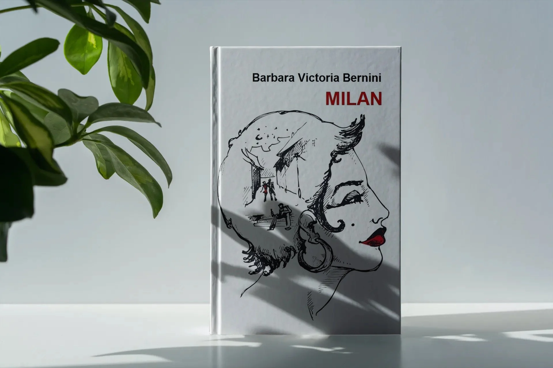 A book titled 'Milan' by Barbara Victoria Bernini displays a black and white illustration of a woman's profile with red lips and a large earring, with a cityscape scene inside her head, and is placed next to a leafy green plant on a white surface with a plain light background.