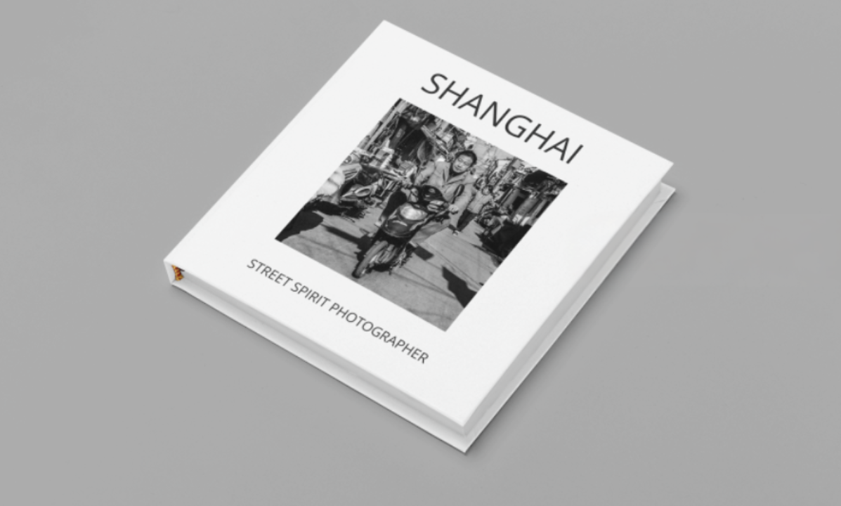 Book titled 'Shanghai' with subtitle 'Street Spirit Photographer' featuring a black and white photograph of a person riding a scooter in a street in Shanghai.