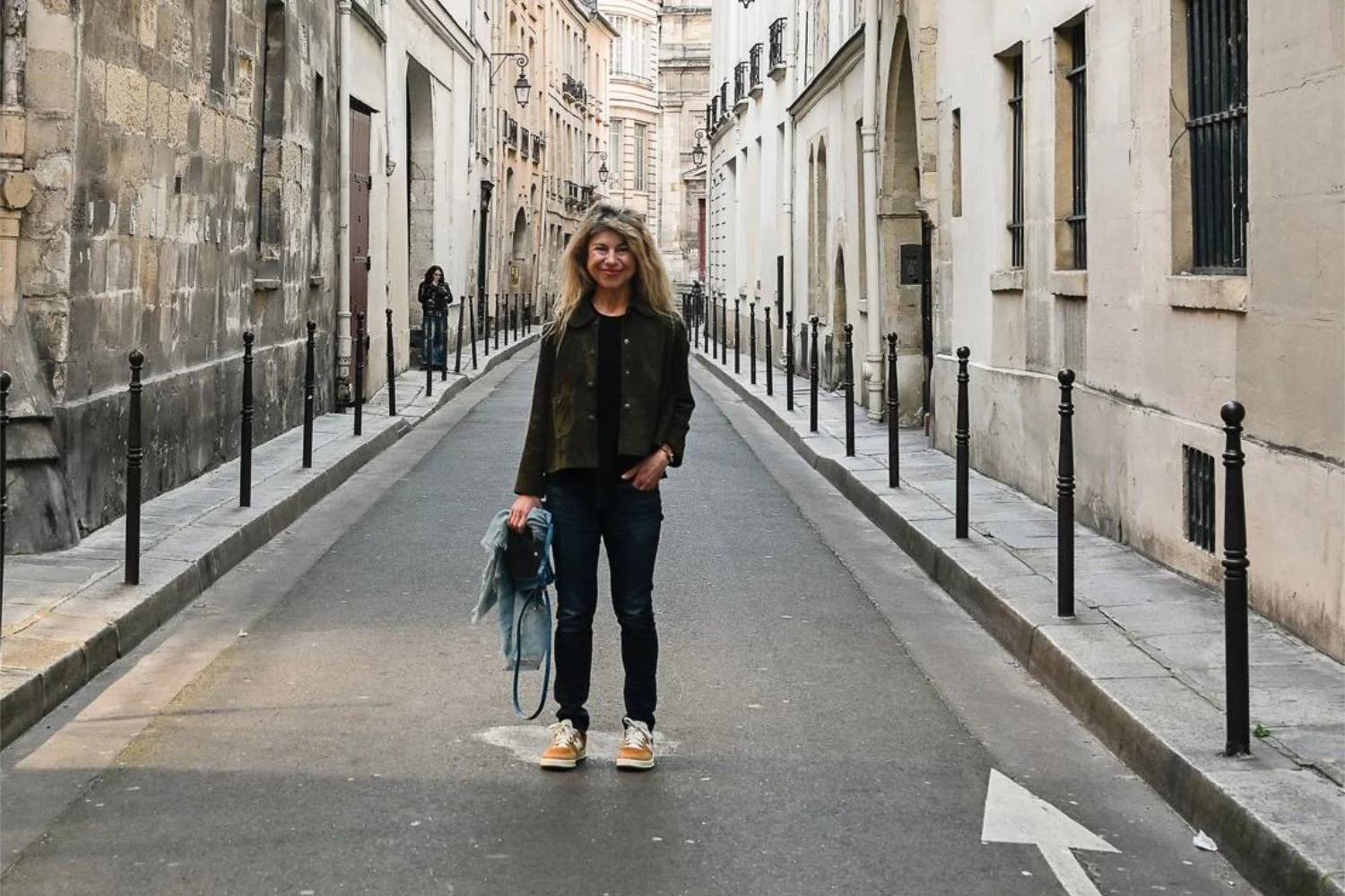 Woman standing confidently on a quiet Paris street — representing identity, authenticity, and living by your values