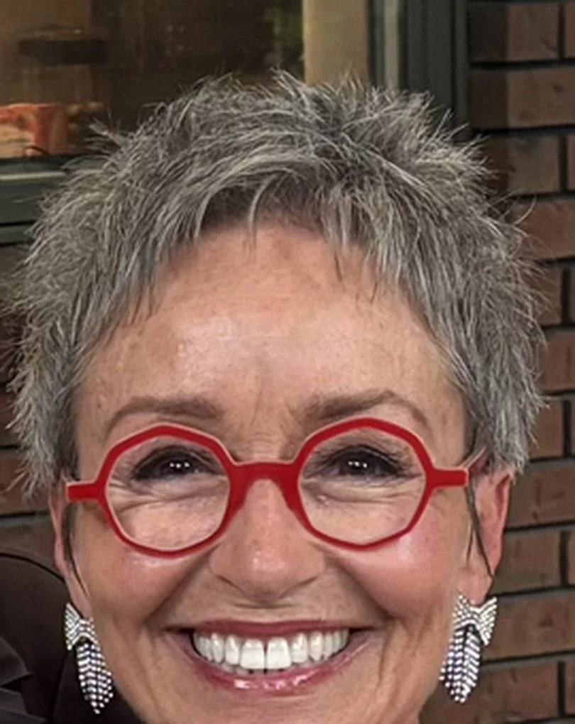 Shelley Kappel, BCRC's Retreat Mama, smiling in red glasses