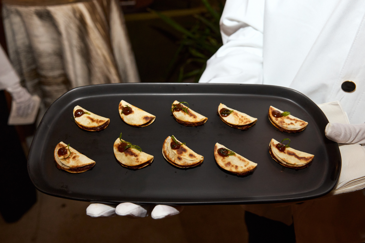 A server holding a platter of food ready to be handed out