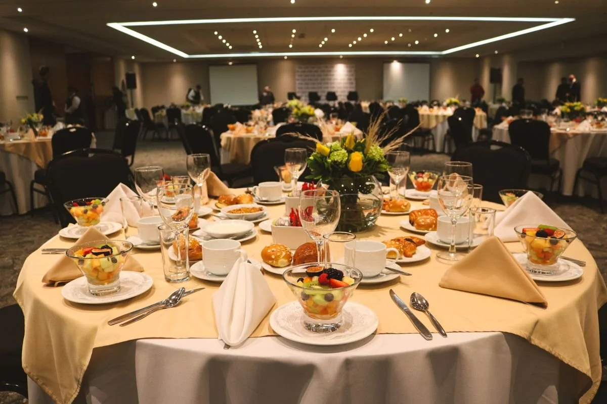 A table with a bunch of other tables around with fruit on them