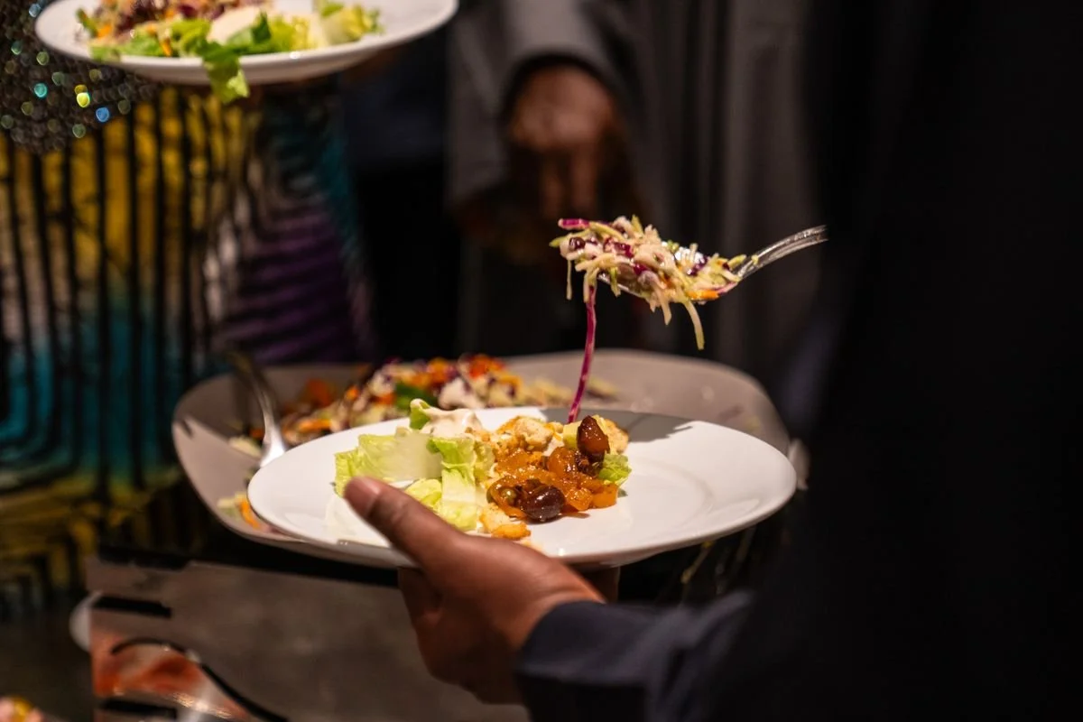 Someone making. plate of food at a catering event