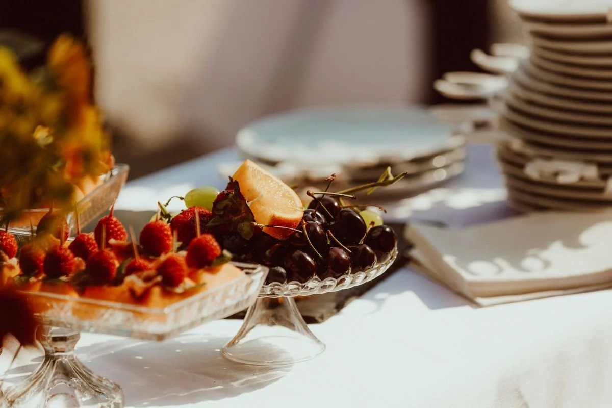 A bunch of little fruit cups on a table