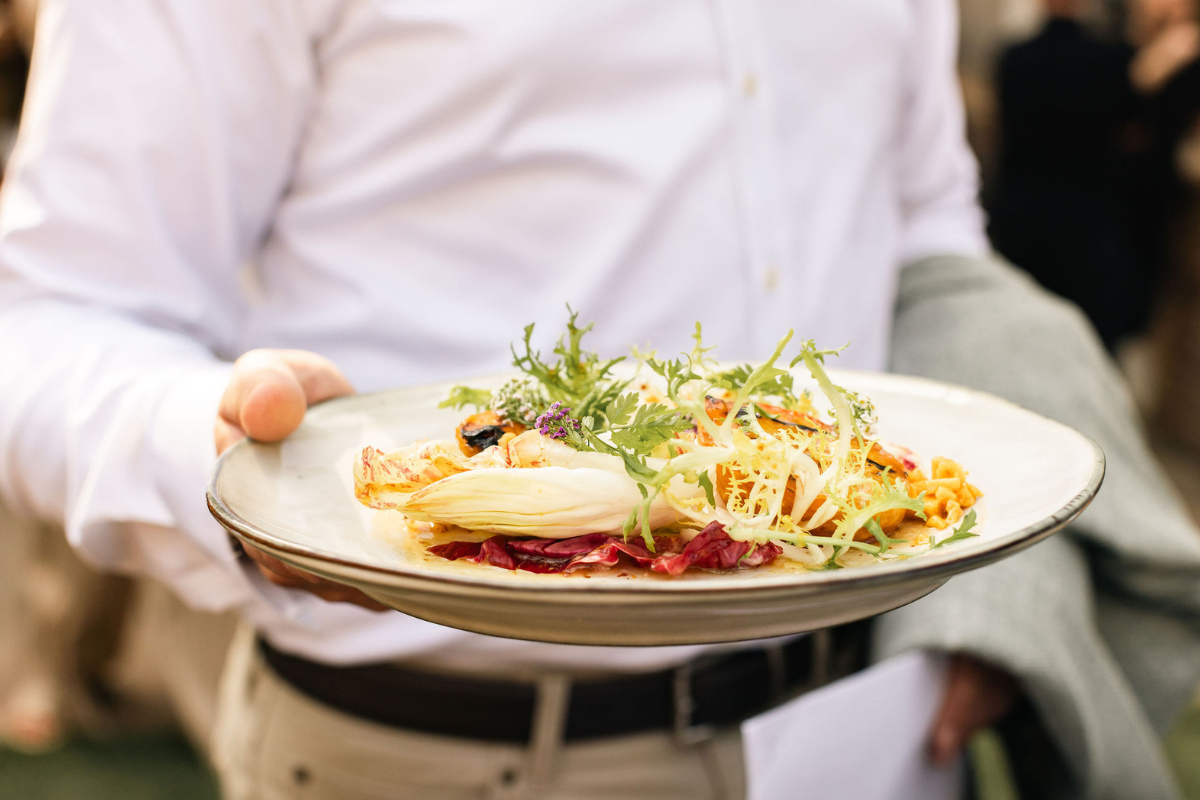 A person holding a plate in front of the camera