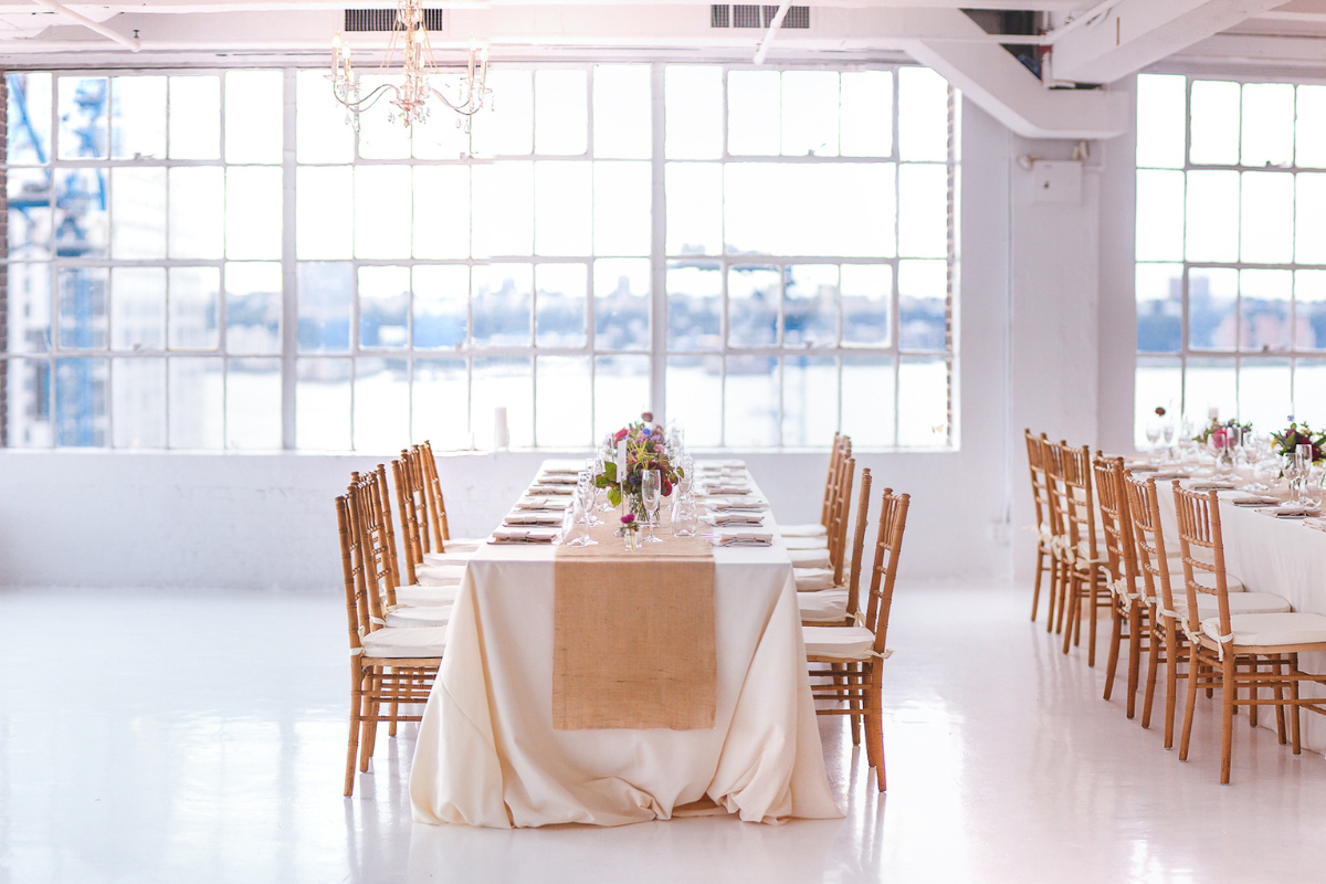 A room with a bunch of chairs and tables ready for an event