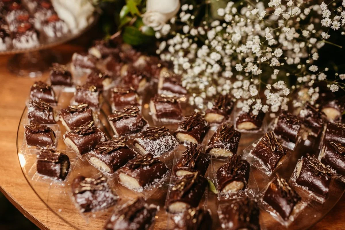 A bunch of little chocolates sitting on a platter