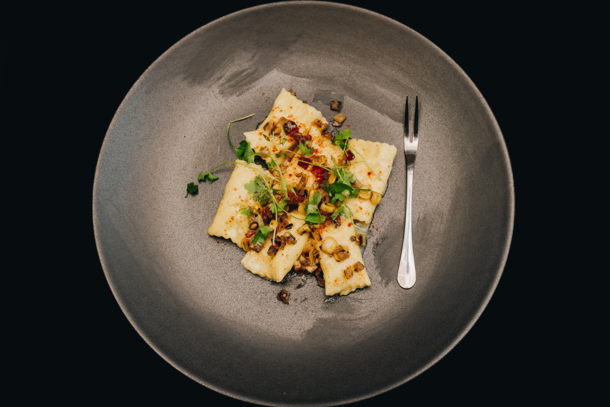 A plate with some food and a fork on it