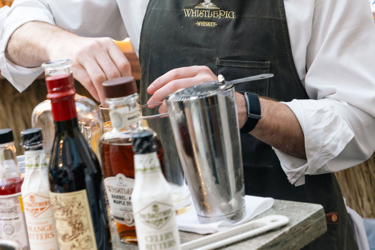 A person making alcohol at a bar