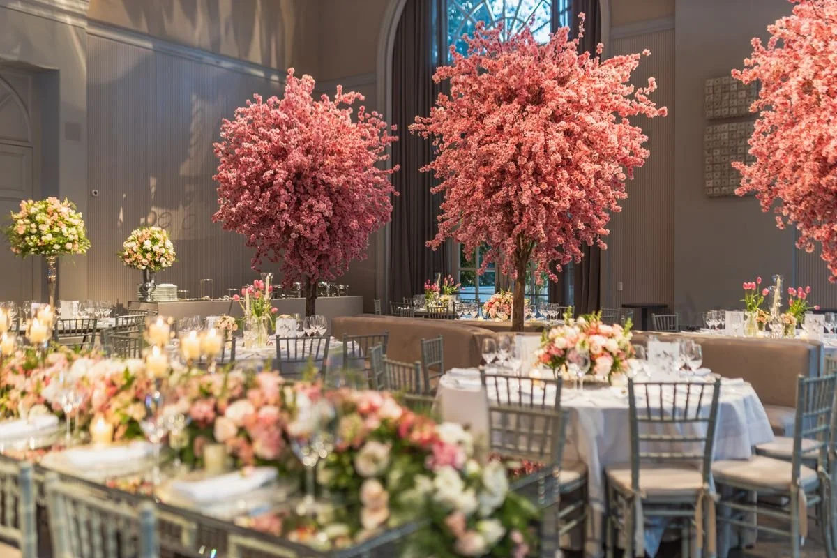A room with a bunch of flowers at a wedding venue