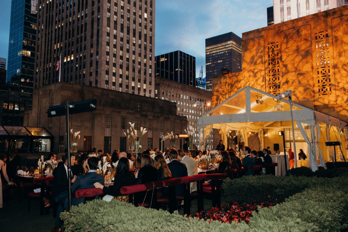 A wedding venue with a ton of people sitting at tables