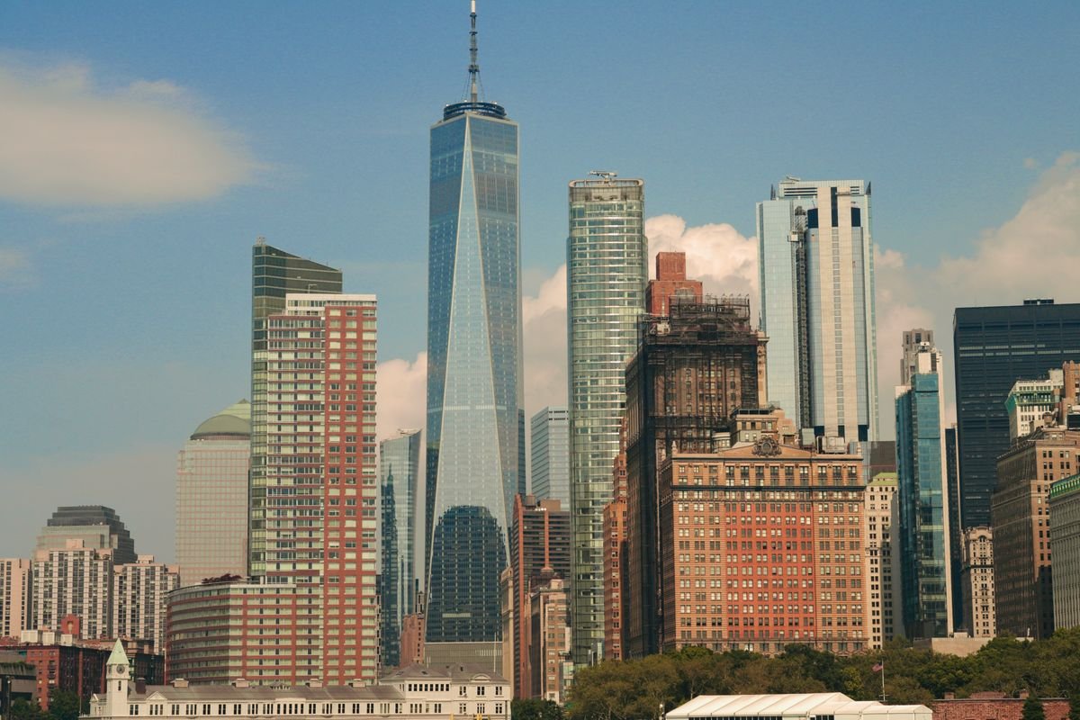 A view of New York City from the ground looking up at the skyscrapers